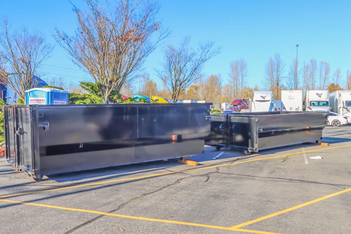 Professional dumpster rental service with roll-off container on residential driveway in Zanesville